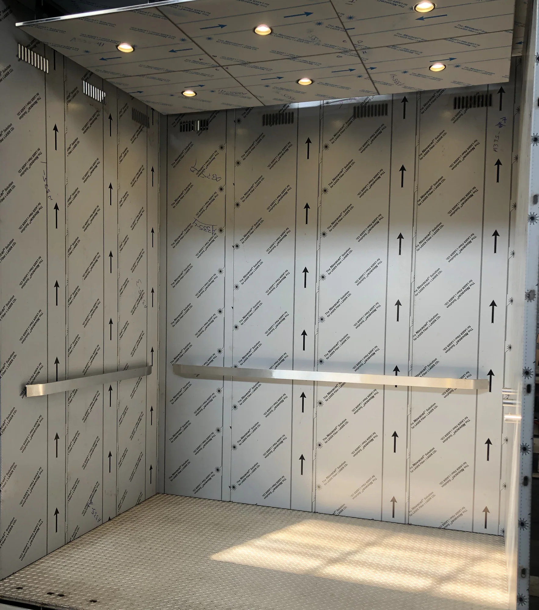 Transit elevator cab for the 51st Street Metra station with patterned protective panels