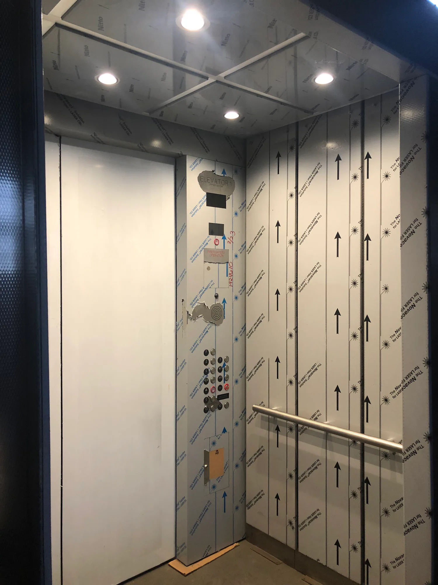 Stainless elevator interior at Argonne National Laboratory with dark ceiling and integrated lighting