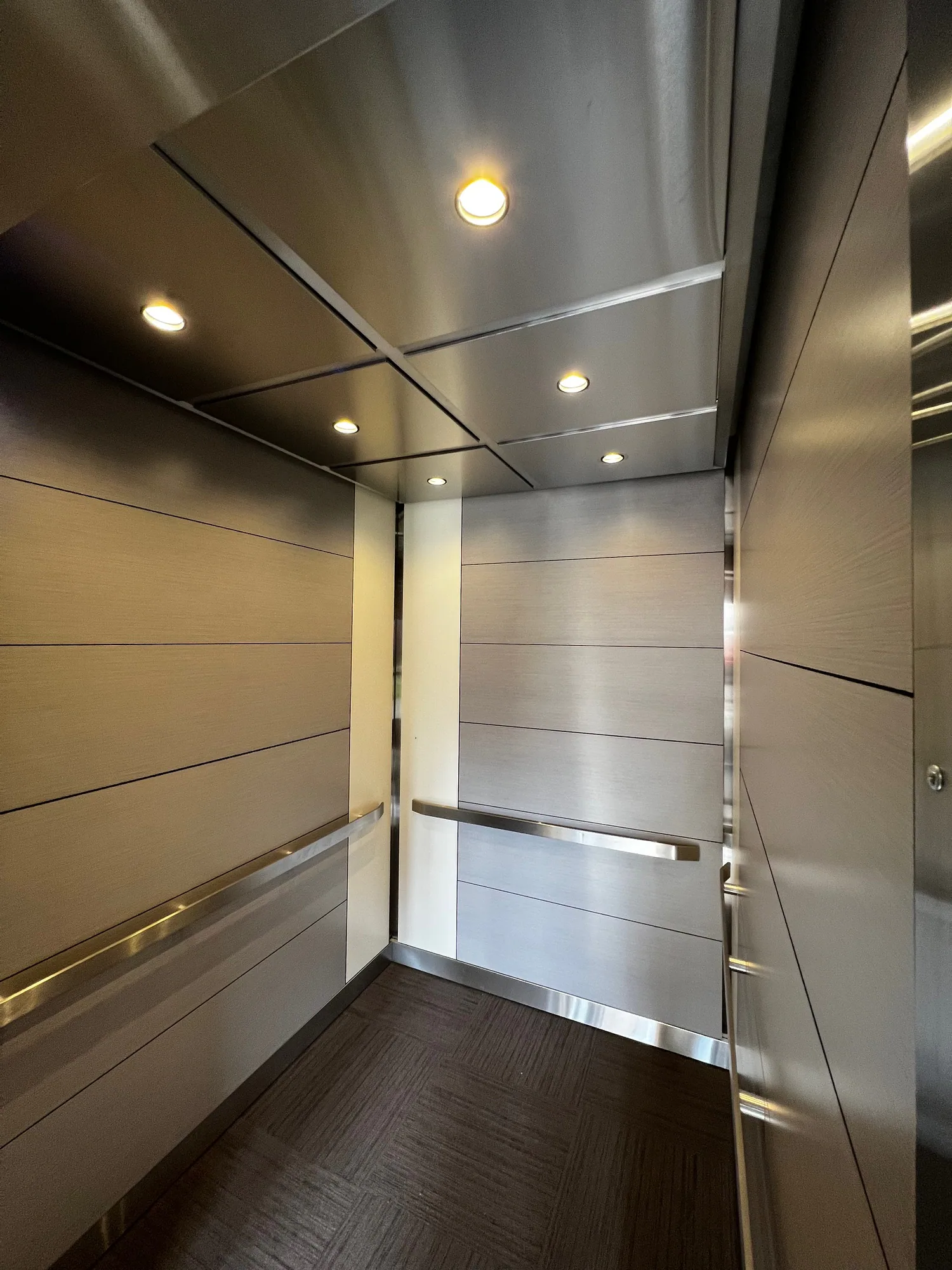 Kankakee College elevator cab with stainless walls and coordinated handrails