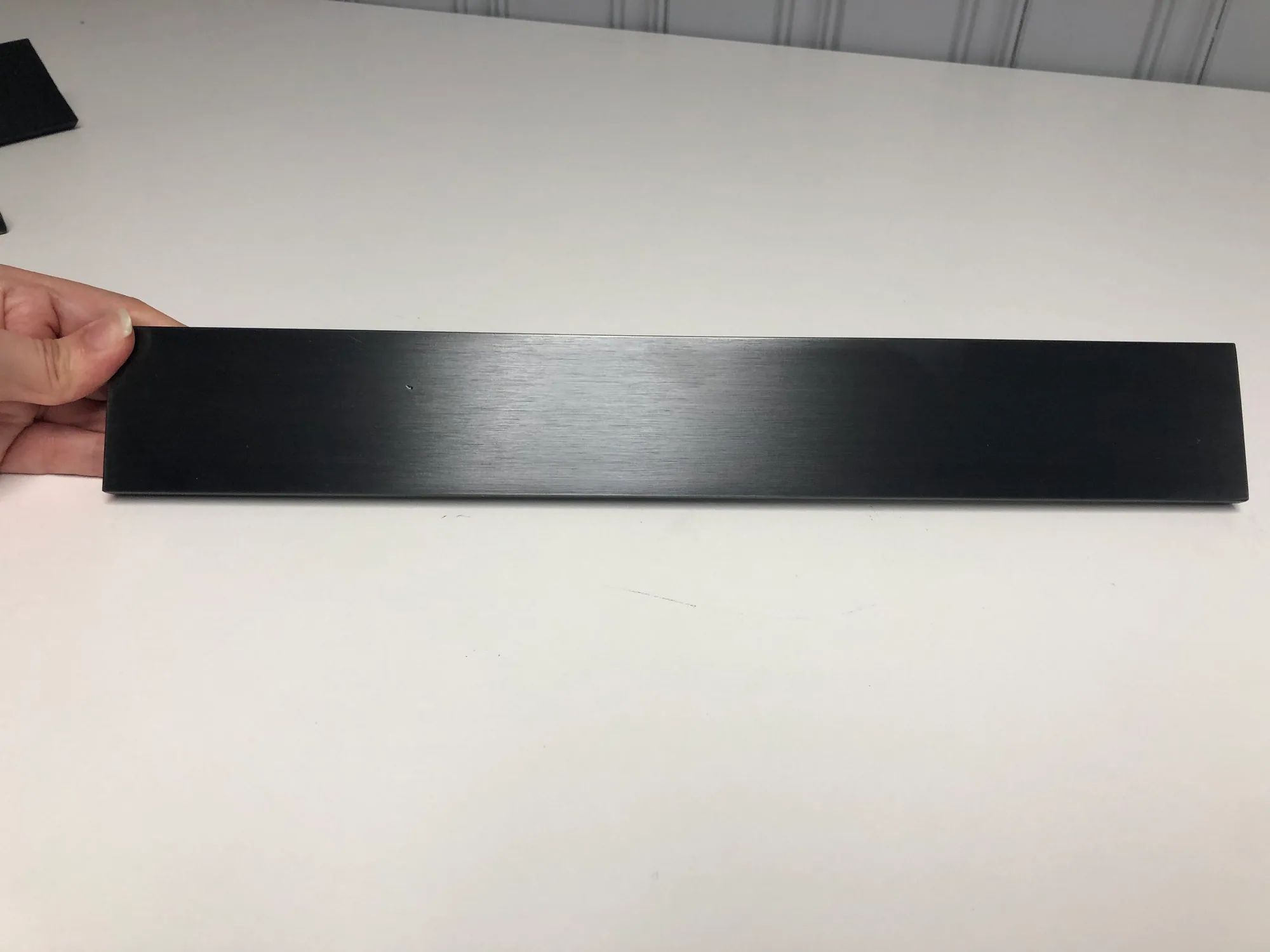 Blackened stainless steel elevator handrail finish sample