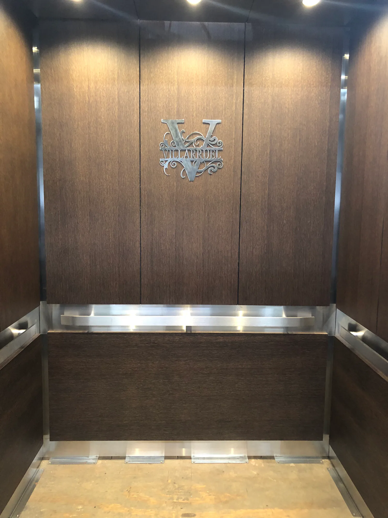 Hyde Park elevator cab with dark wood panels and stainless lower wall protection