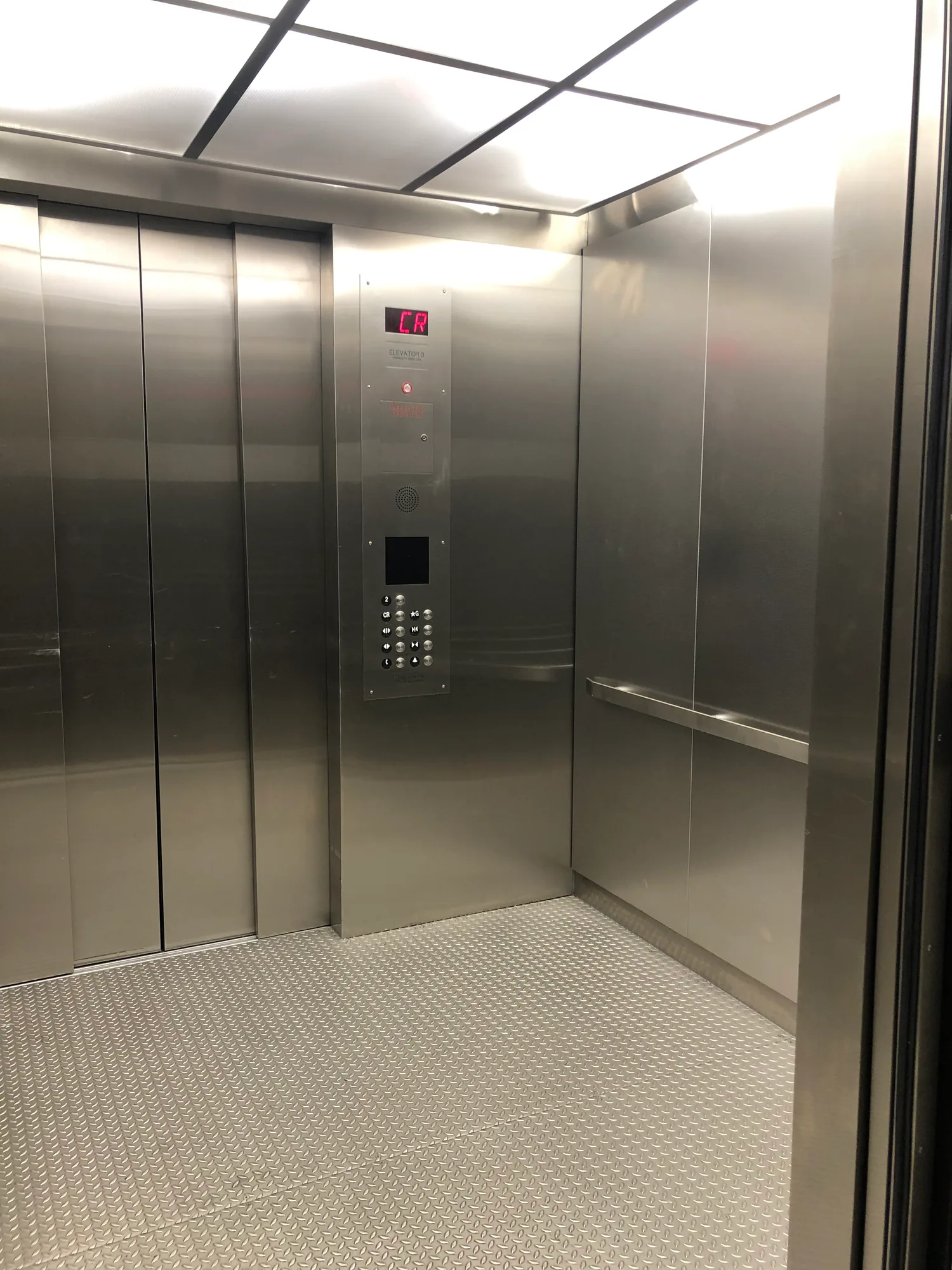 Stainless elevator cab at a juvenile detention facility with a luminous ceiling
