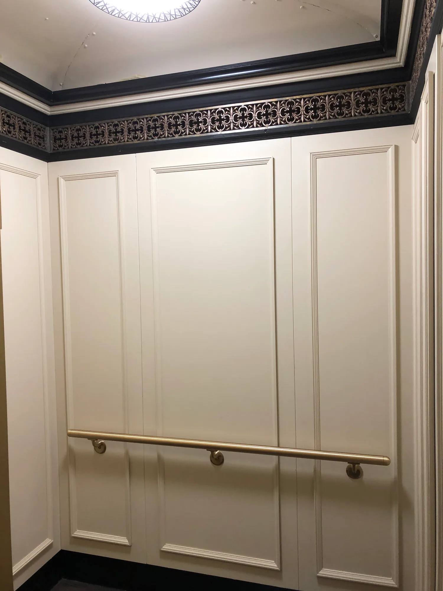 Classic light paneled elevator interior at the Patricians in Chicago