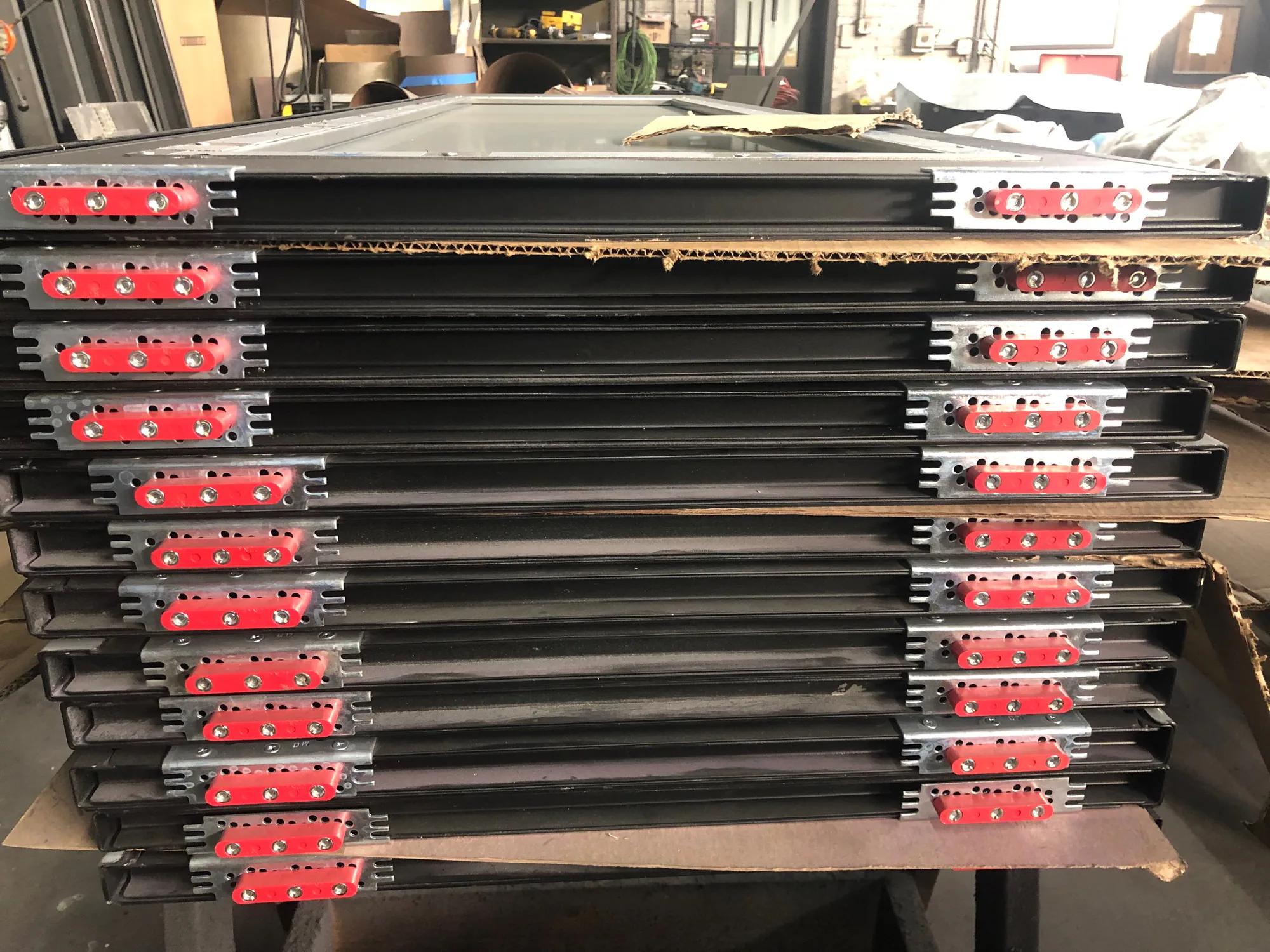Stacked transit elevator door components prepared in the JV shop